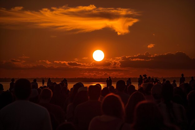 Large group enjoys watching sunset over ocean mesmerized by colors in the sky