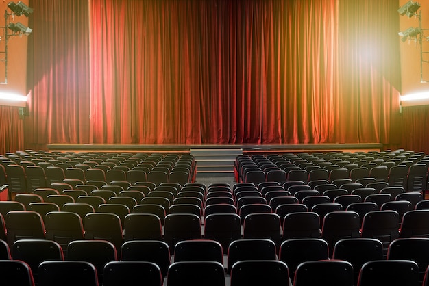 Large illuminated theatre hall with empty seats