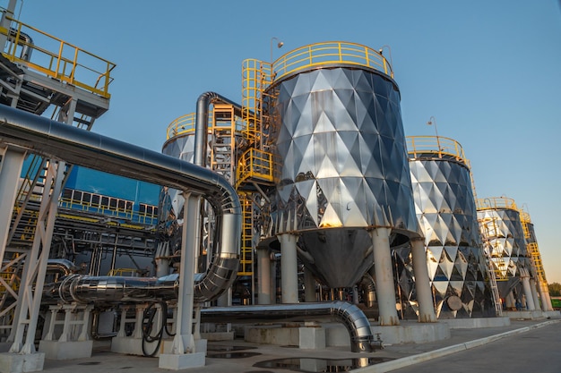 A large industrial plant with a blue sky behind it