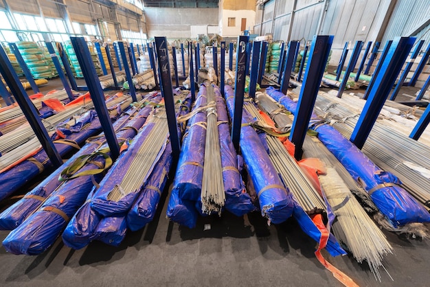 Large industrial warehouse of coldrolled metal bar Bundles of metal rods are stacked