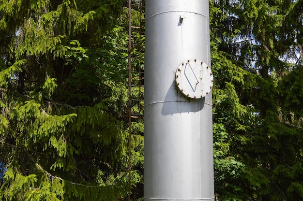 Large iron metal stainless brilliant industrial tank column with a folding round hatch manhole