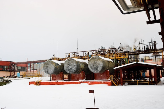 Large iron tanks ladders and protective fencing pipes equipment and machine tools valves heat exchangers at a petroleum refining petrochemical chemical industrial plant