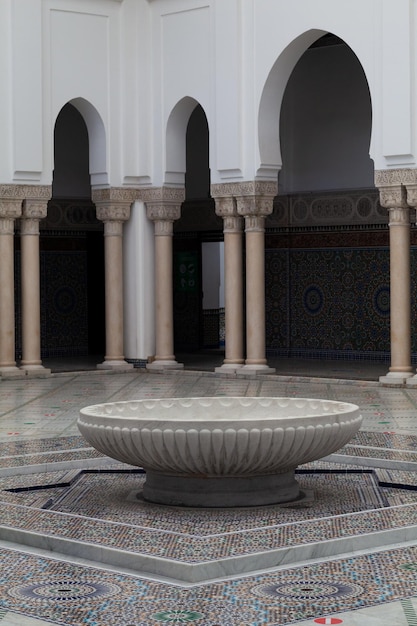 The large marble basin in the middle of the Grand Mosque of Paris full of beautiful mosaics