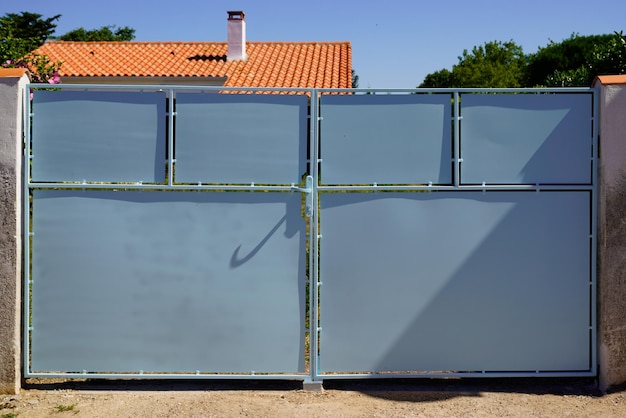 Large metal gate grey fence on access facade street house