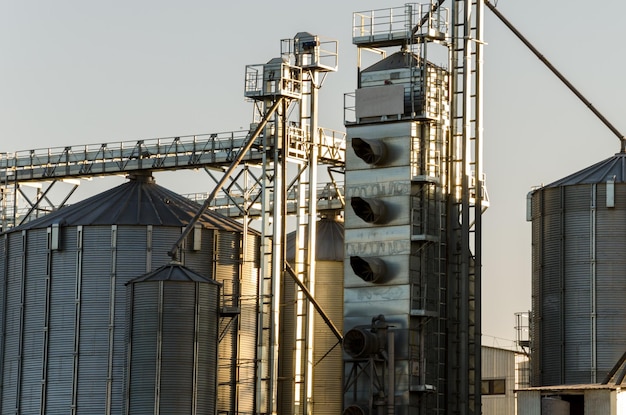 A large modern plant for the storage and processing of grain crops view of the granary on a sunny day against the blue sky End of harvest season