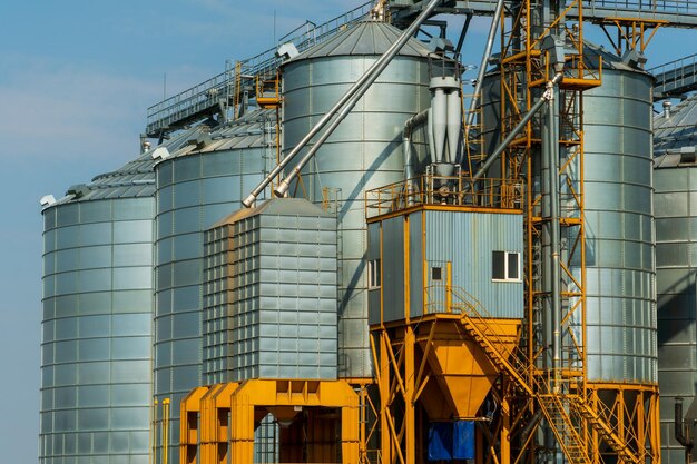 A large modern plant for the storage and processing of grain crops view of the granary on a sunny day against the blue sky End of harvest season