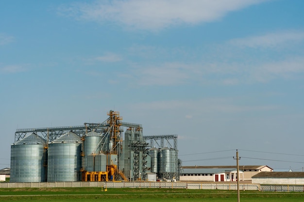 A large modern plant for the storage and processing of grain crops view of the granary on a sunny day against the blue sky End of harvest season