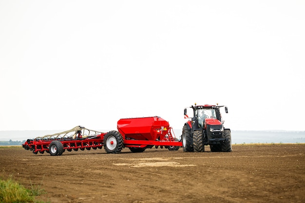 Large modern tractor for preparing the field after winter for sowing grain. Agricultural machinery