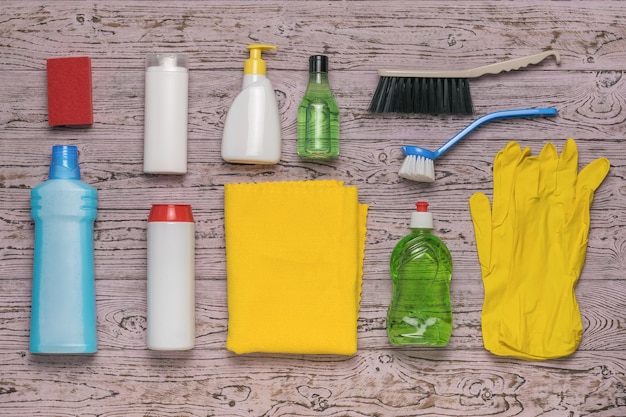 A large number of accessories and cleaning products on a wooden background Cleaning kit