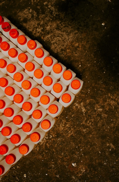 A large number of bottles with a red lid