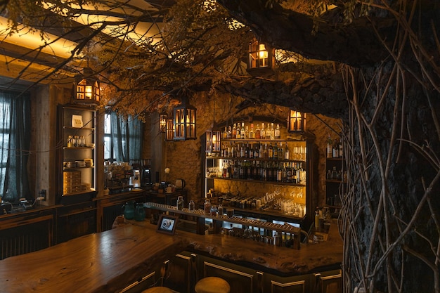 Large old decorative tree and empty bar in restaurant