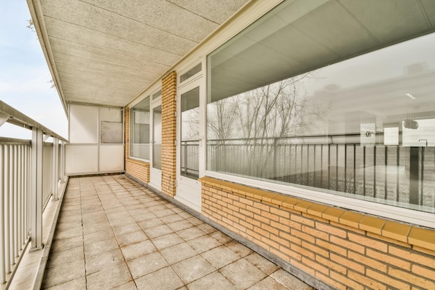 Large oldfashioned balcony with metal fences and tiled floor in a cozy house