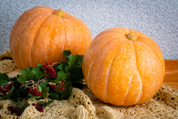 A large orange pumpkin lies on a wooden table