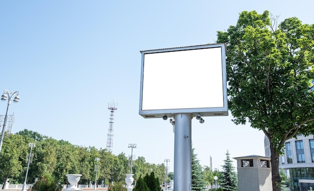 Large outdoor billboard mockup on beautiful city background with trees Brand product service promotion Hoarding