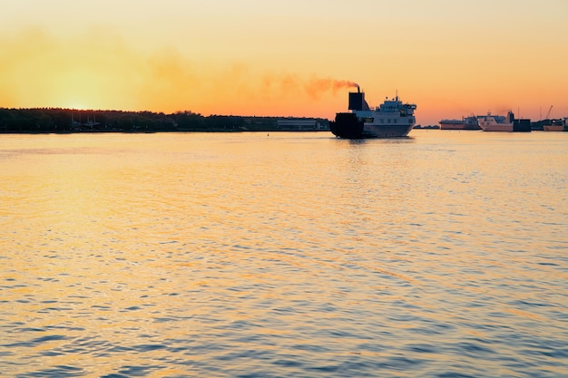 Large passenger ferry ship in the Port of Klaipeda in Lithuania, Eastern European country on the Baltic sea. At romantic sunset