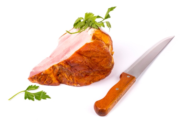 A large piece of fresh pork ham and a kitchen knife on a white background