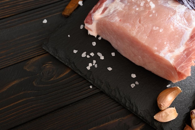 A large piece of pork loin on a rustic dark background