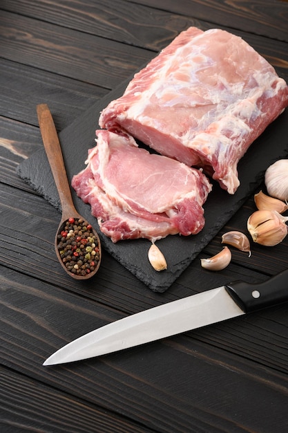 A large piece of pork loin on a rustic dark background