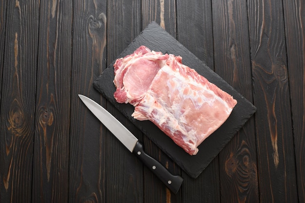 A large piece of pork loin on a rustic dark background