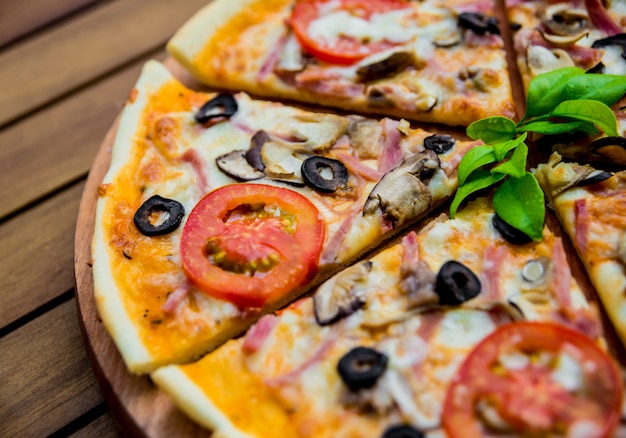 Large pizza on a wooden table. Restaurant.