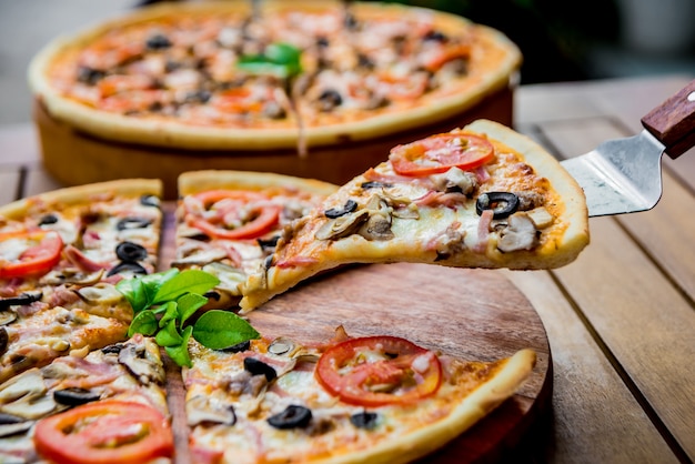 Large pizza on a wooden table. Restaurant.