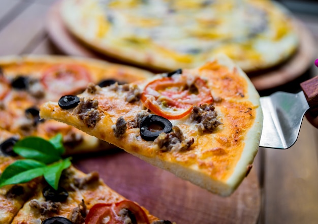 Large pizza on a wooden table.