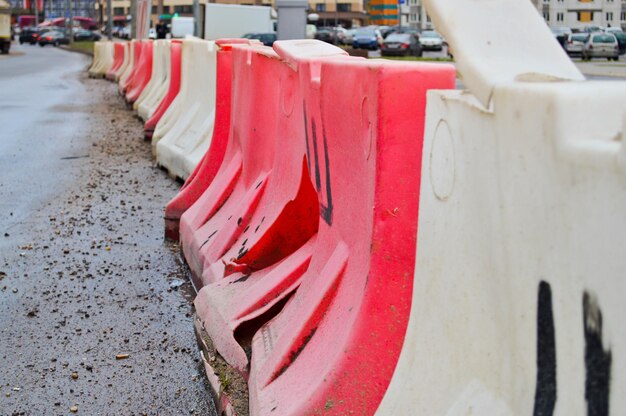 Large plastic red and white enclosure blocks filled with water for road safety during road repairs