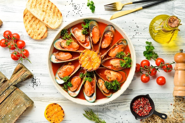 Large plate with mussels cooked in tomato sauce with garlic parsley and lemon Free space for your text