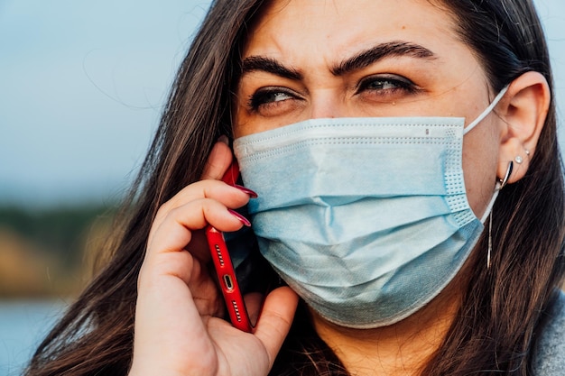 Large portrait of a young woman in a medical mask