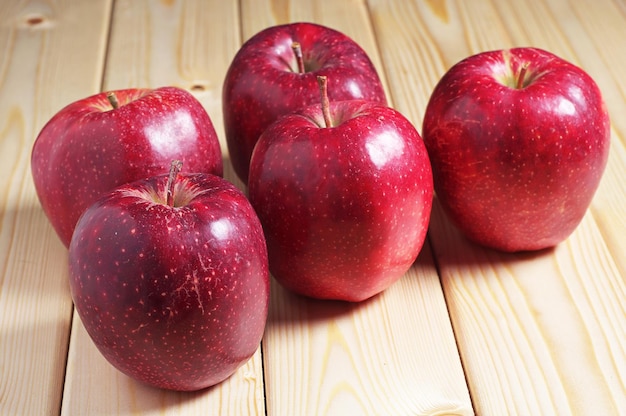 Large red apples on a wooden table