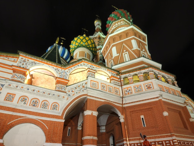 A large red brick building with a large dome and a green dome on the front.