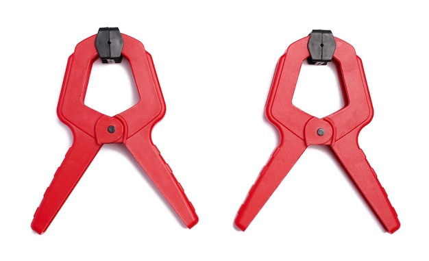 Large red plastic clamp on a white isolated background