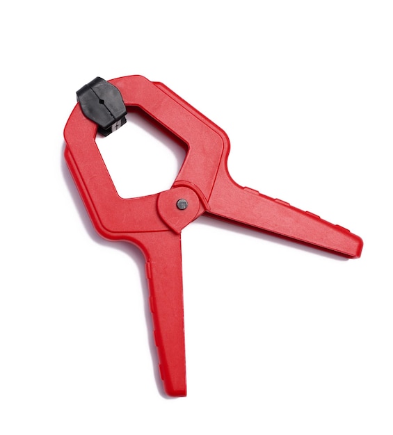 Large red plastic clamp on a white isolated background