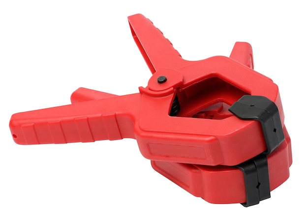 Large red plastic clamp on a white isolated background