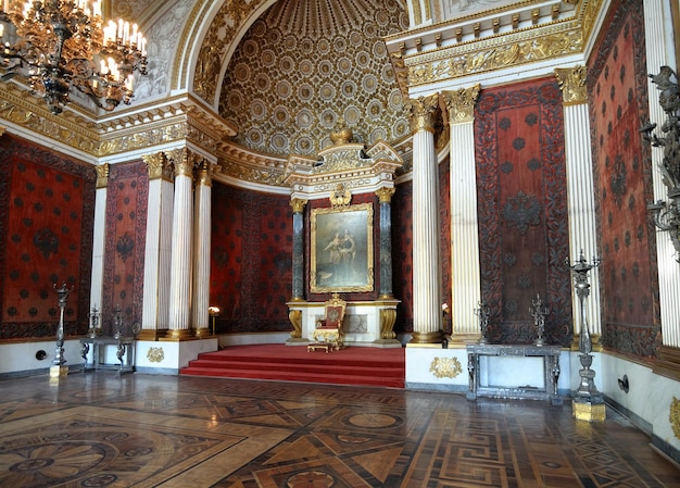 A large room with a painting on the wall and a chair in the middle of it.