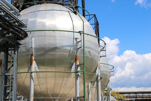 A large round ballshaped shiny metallic highpressure iron storage tank for ammonia