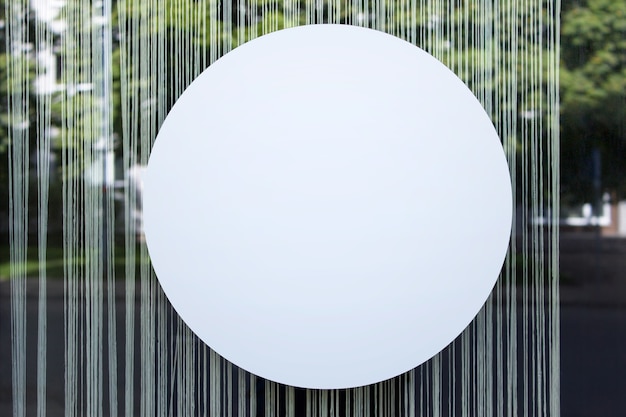 Large round circle shop banner mockup template hanging on glass shop window