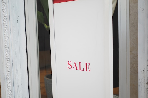 Large sale text letters on red background on clothing store