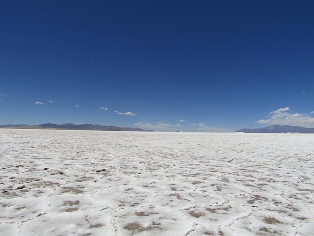 A large salt lake with a few clouds in the sky.