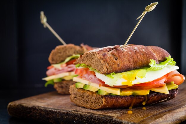 Large sandwich with avocado ham chese and egg