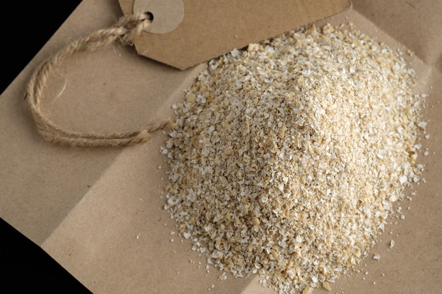 Large size oat bran, useful, cleansing, for a healthy diet on a black background