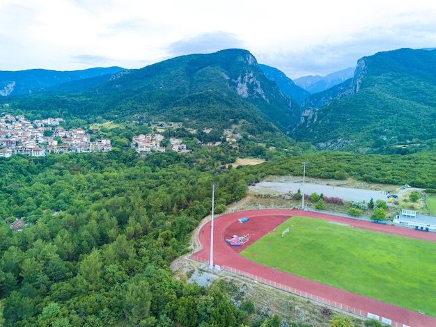 Large sports ground near the greek town of litochoro against the backdrop of the mount olympus and a