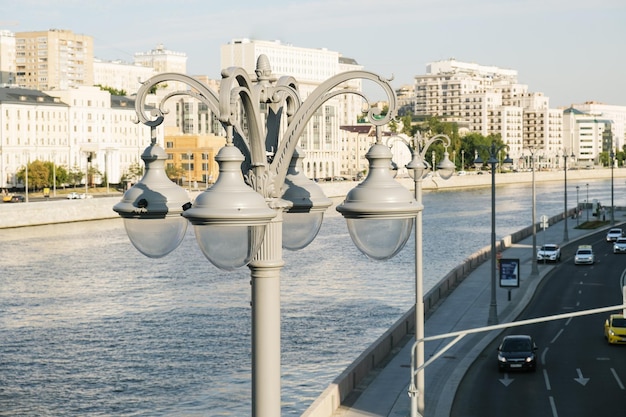 Large street electric lamps on a pole on the embankment of the river