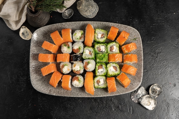 Large sushi set of rolls and nigiri with salmon and chuka salad