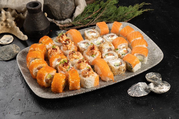 Large sushi set of rolls and nigiri with salmon and flying fish caviar