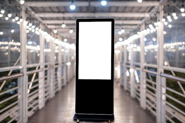 A large vertical blank billboard is mounted on the walkway