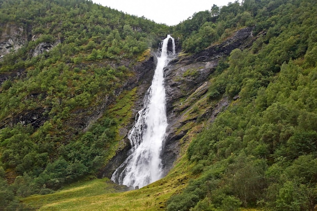 Large waterfall in mountainous and wooded areas