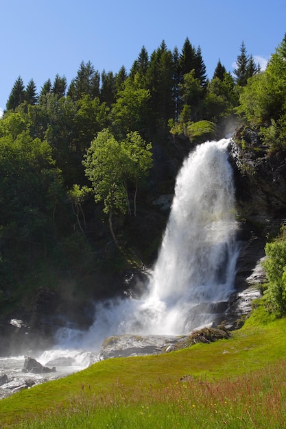 Large waterfall in the summer woods, norway