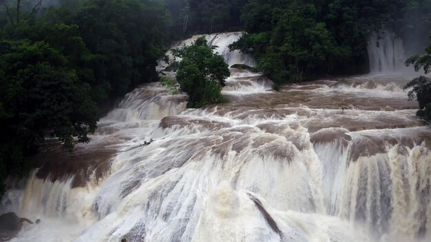 A large waterfall with trees in the background