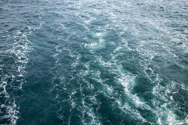 Large waves with sharp gusts of wind top view water